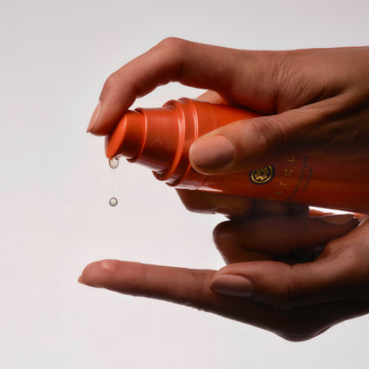 Hands pumping out the Tatcha Brightening Serum