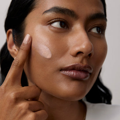 Model application showcasing the Tatcha Silk Sunscreen